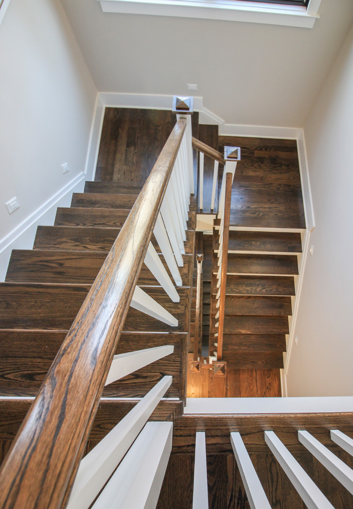 Photo of a mid-sized modern travertine u-shaped staircase in DC Metro with wood risers and wood railing.
