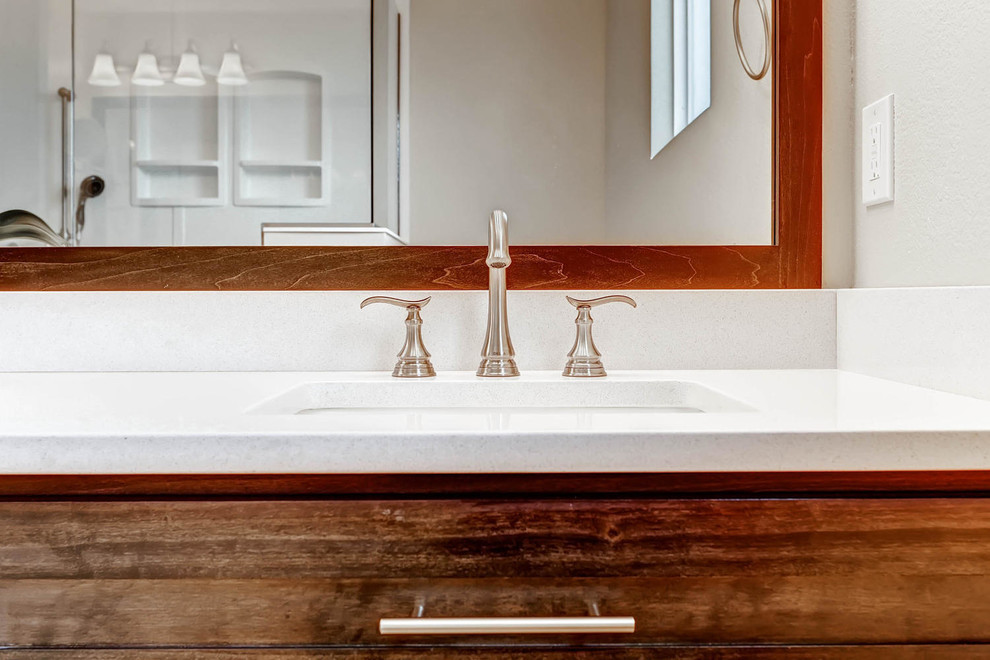 Doorless shower - small transitional master cement tile ceramic tile doorless shower idea in Denver with shaker cabinets, dark wood cabinets, a one-piece toilet, beige walls, an undermount sink and quartz countertops