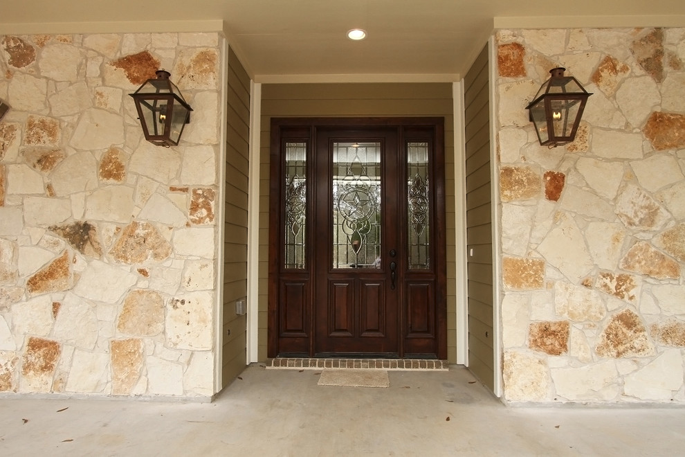 Inspiration for an arts and crafts entryway in Houston with a single front door and a dark wood front door.