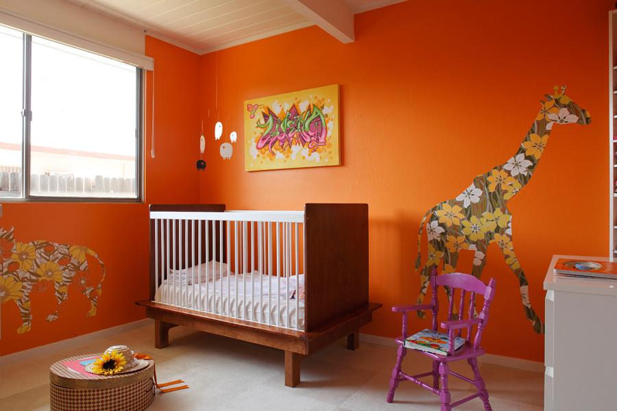 Midcentury gender-neutral kids' bedroom in Orange County with orange walls.