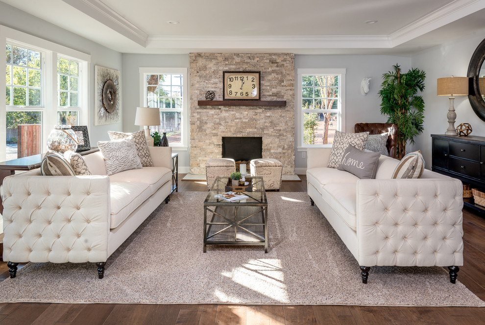 Inspiration for a mid-sized country formal open concept living room in San Francisco with medium hardwood floors, a standard fireplace, a stone fireplace surround, green walls, no tv and beige floor.