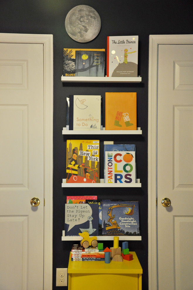 Astronomer's Observatory - A Child's Room - This navy kid's room is filled with bright moments of orange and yellow. Ralph Lauren's Northern Hemisphere is covering the ceiling, inspiring exploration in space and ocean.  A Solar System mobile and light-up Moon provide great fun to this sophisticated yet playful space.