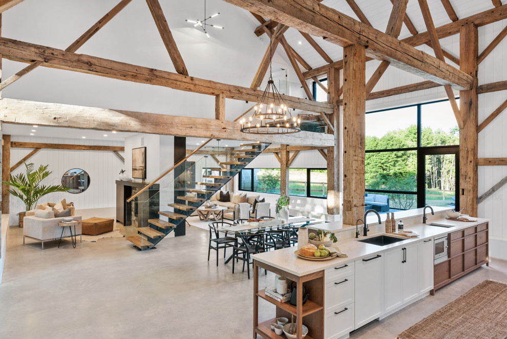 Eat-in kitchen - large transitional galley eat-in kitchen idea with an undermount sink, shaker cabinets, white cabinets, quartz countertops, white backsplash, quartz backsplash, paneled appliances, an island and white countertops