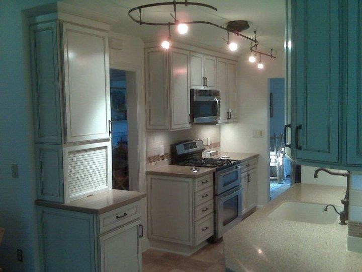 Kitchen photo in DC Metro with white cabinets, beige backsplash and stainless steel appliances