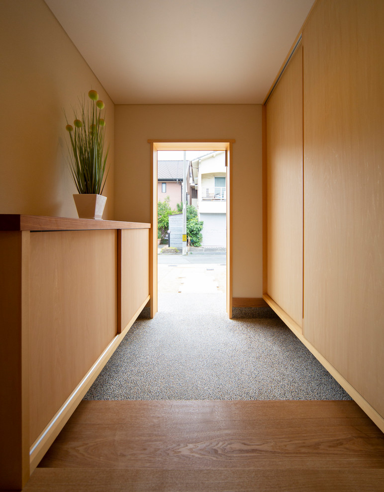 This is an example of an asian entryway in Other with grey floor.