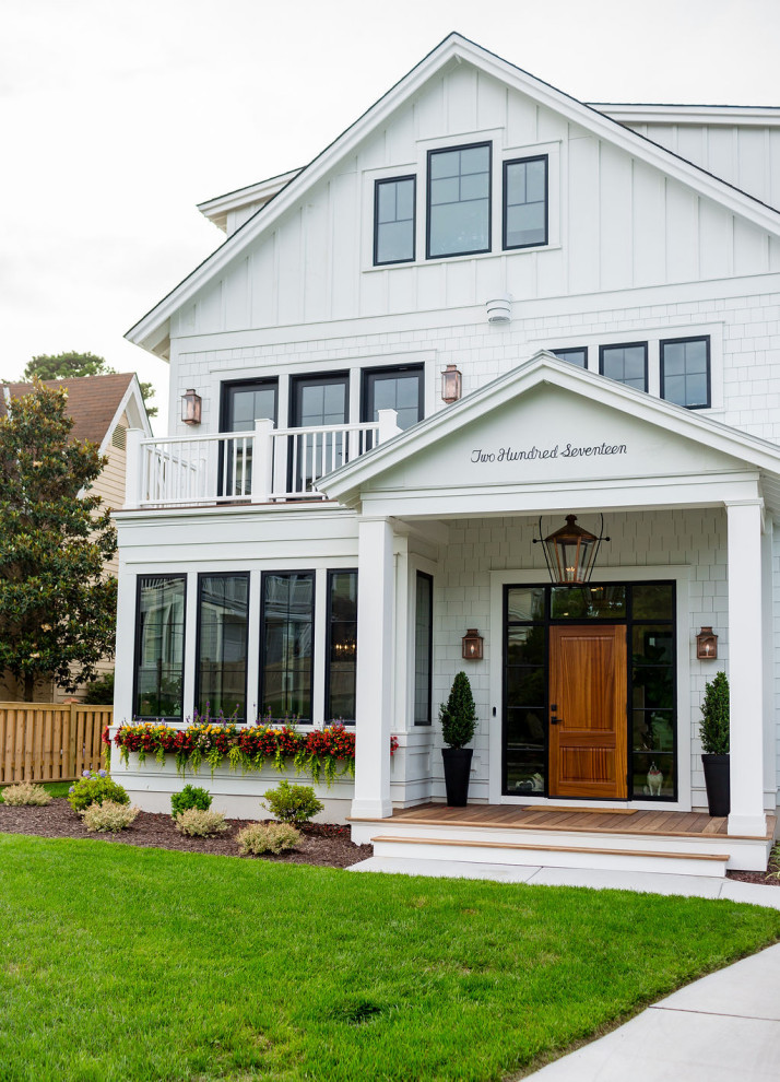 Inspiration for a large country white three-story concrete fiberboard and shingle house exterior remodel