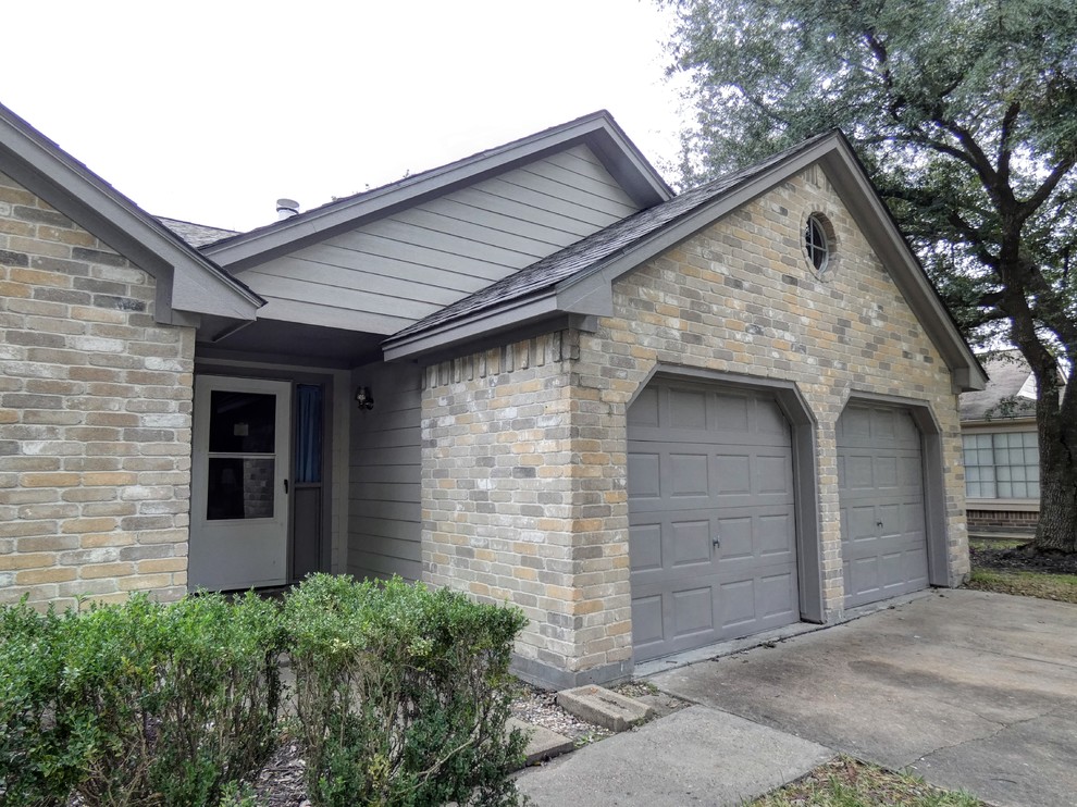 This is an example of a mid-sized traditional one-storey grey house exterior in Houston with concrete fiberboard siding, a gable roof and a shingle roof.