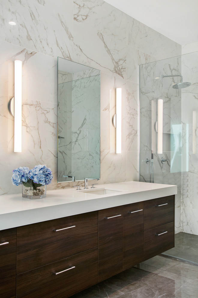 Inspiration for a large modern master bathroom in Tampa with flat-panel cabinets, dark wood cabinets, a freestanding tub, a curbless shower, a two-piece toilet, white tile, porcelain tile, white walls, porcelain floors, an undermount sink, engineered quartz benchtops, grey floor, an open shower and white benchtops.