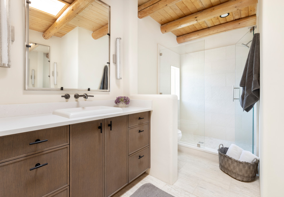 Mid-sized 3/4 wet room bathroom in Albuquerque with flat-panel cabinets, stone tile, porcelain floors, beige floor, a hinged shower door, a single vanity, a built-in vanity and wood.