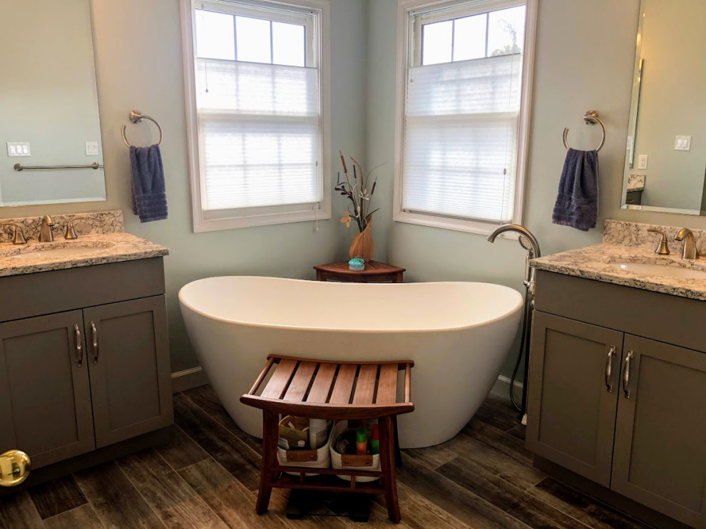 Mid-sized transitional master gray tile and porcelain tile porcelain tile, gray floor, double-sink and vaulted ceiling bathroom photo in Baltimore with shaker cabinets, gray cabinets, a one-piece toilet, blue walls, an undermount sink, quartz countertops, multicolored countertops and a freestanding vanity