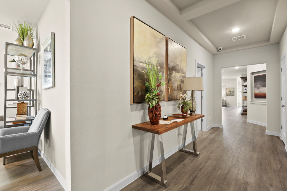 Inspiration for a mid-sized contemporary foyer in Dallas with medium hardwood floors and brown floor.
