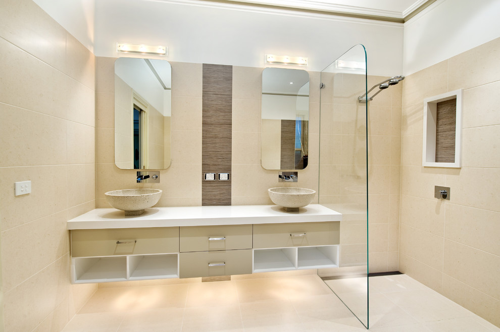 This is an example of a large contemporary master bathroom in Melbourne with a vessel sink, a curbless shower, beige tile, porcelain tile, porcelain floors, beige floor and white benchtops.