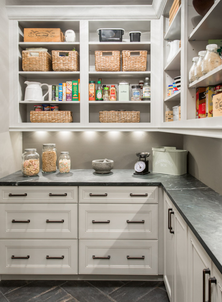 Design ideas for a transitional l-shaped kitchen pantry in St Louis with white cabinets, soapstone benchtops, porcelain floors, open cabinets, grey splashback, black floor and black benchtop.