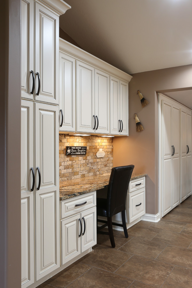 Inspiration for a large transitional u-shaped porcelain tile and brown floor open concept kitchen remodel with a farmhouse sink, raised-panel cabinets, white cabinets, granite countertops, beige backsplash, travertine backsplash, stainless steel appliances and an island