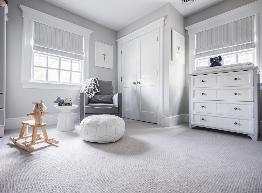 Photo of a mid-sized transitional gender-neutral nursery in New York with grey walls, carpet and grey floor.