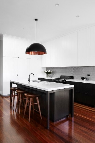 This is an example of a contemporary kitchen in Newcastle - Maitland with a submerged sink, engineered stone countertops, grey splashback, metro tiled splashback, black appliances and dark hardwood flooring.