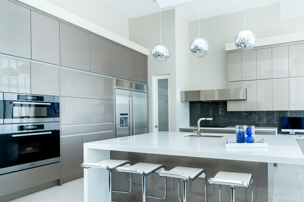 Inspiration for a large contemporary l-shaped porcelain tile eat-in kitchen remodel in Calgary with an undermount sink, flat-panel cabinets, gray cabinets, quartz countertops, gray backsplash, glass tile backsplash, stainless steel appliances and an island