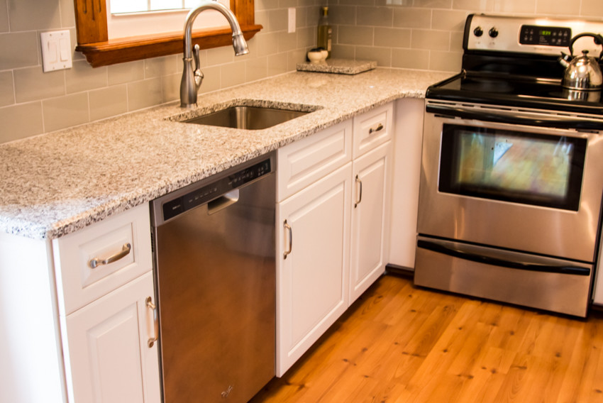 Small transitional u-shaped light wood floor kitchen photo in Baltimore with an undermount sink, raised-panel cabinets, white cabinets and no island
