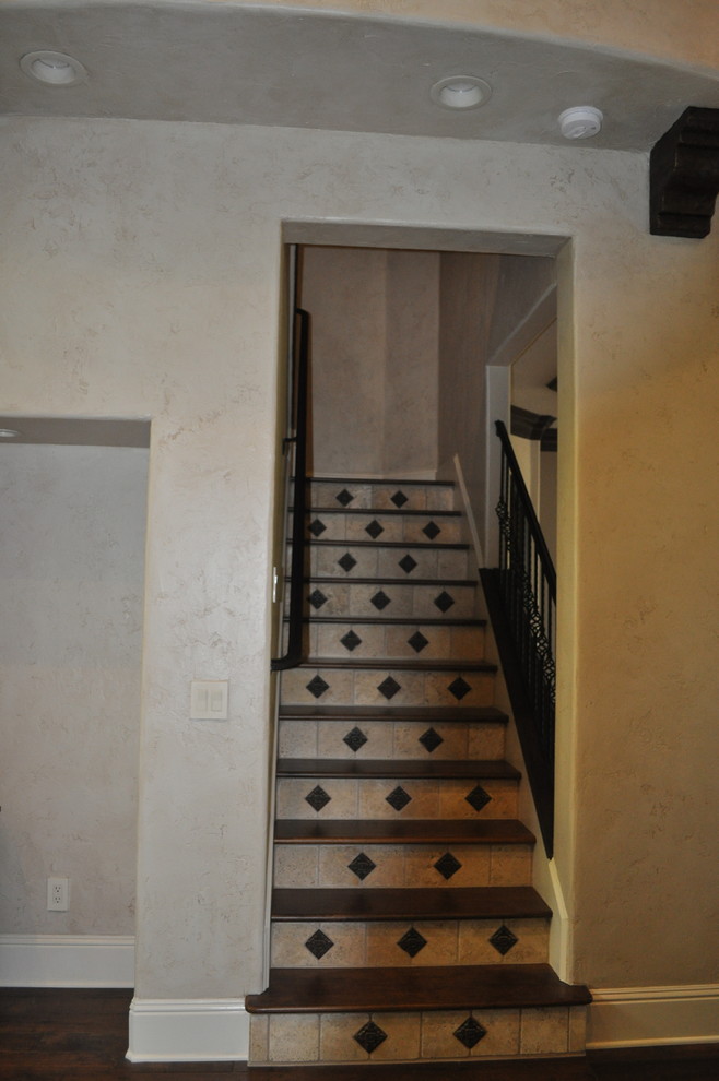 Design ideas for a mid-sized mediterranean wood l-shaped staircase in Orlando with tile risers.