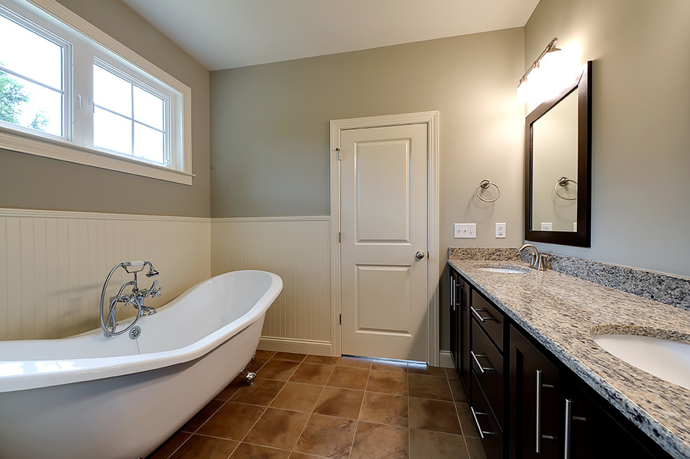 Inspiration for a transitional claw-foot bathtub remodel with an undermount sink, flat-panel cabinets, dark wood cabinets and granite countertops