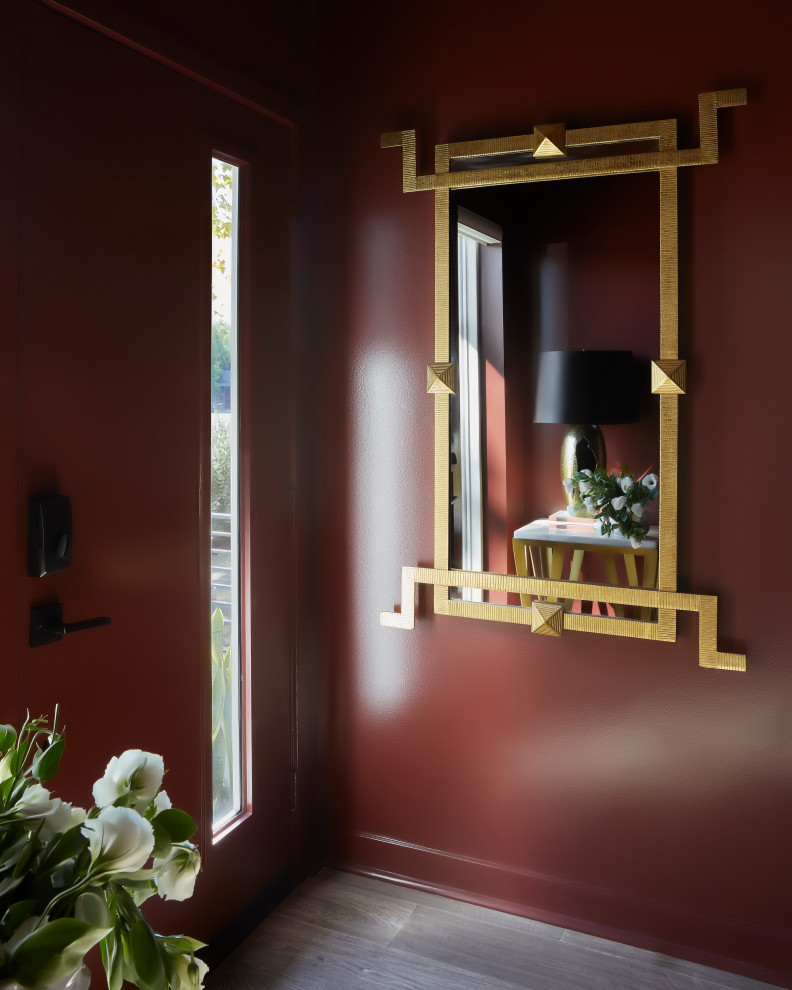 Inspiration for a small eclectic light wood floor and beige floor entryway remodel in Los Angeles with red walls and a red front door