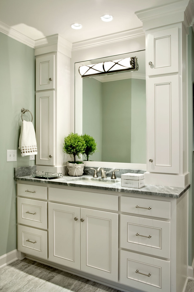 Inspiration for a mid-sized traditional bathroom in Charlotte with recessed-panel cabinets, white cabinets, granite benchtops, gray tile, ceramic tile, a drop-in tub, an undermount sink, ceramic floors and green walls.