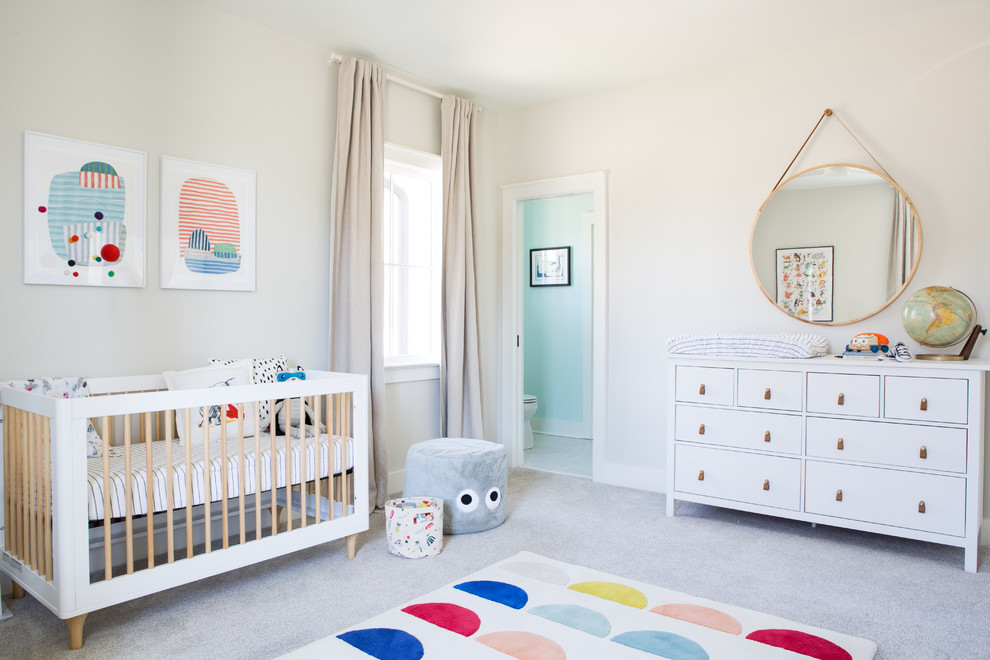 This is an example of a mid-sized contemporary gender-neutral nursery in Other with beige walls, carpet and grey floor.