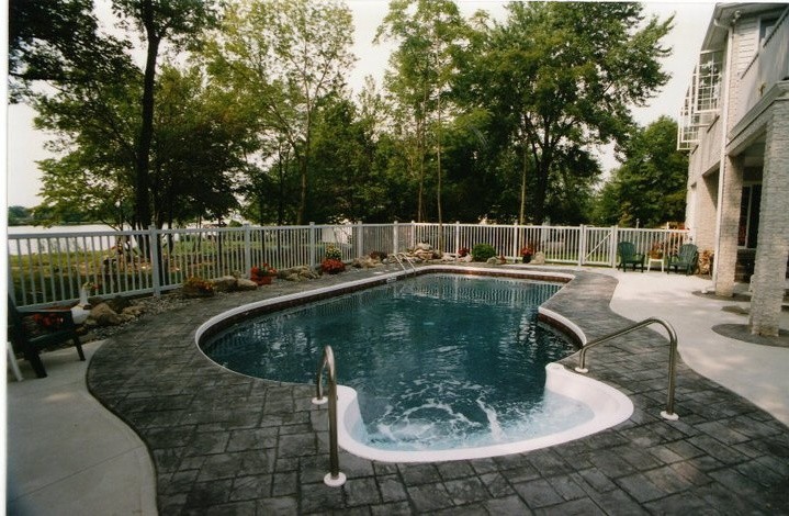 Example of a large backyard stone pool design in Toronto