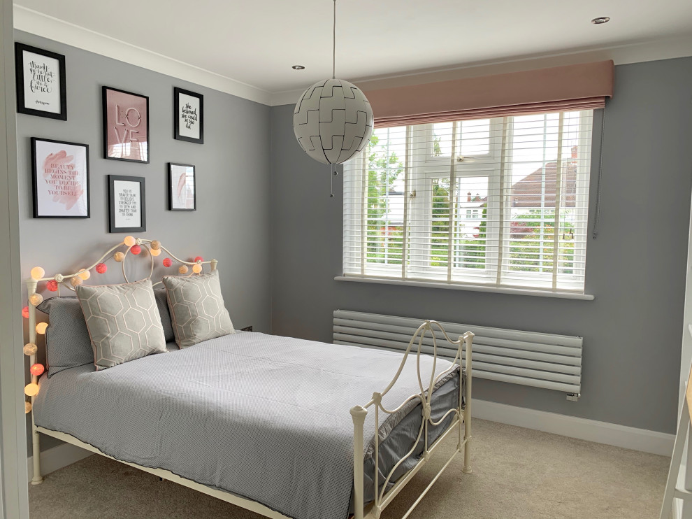 Mid-sized modern bedroom in London with grey walls, carpet and grey floor.