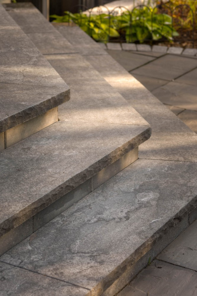 Mid-sized transitional backyard stone patio photo in Toronto