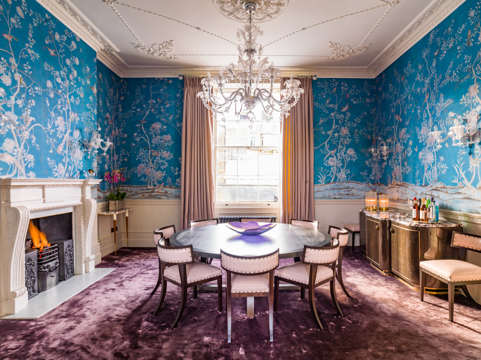 Photo of a large traditional dining room in London with blue walls, carpet, a standard fireplace, a stone fireplace surround and purple floor.