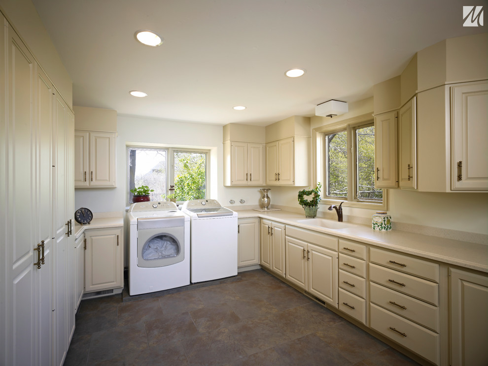 This is an example of a mid-sized transitional u-shaped dedicated laundry room in Salt Lake City with an integrated sink, raised-panel cabinets, beige cabinets, granite benchtops, white walls, ceramic floors and a side-by-side washer and dryer.