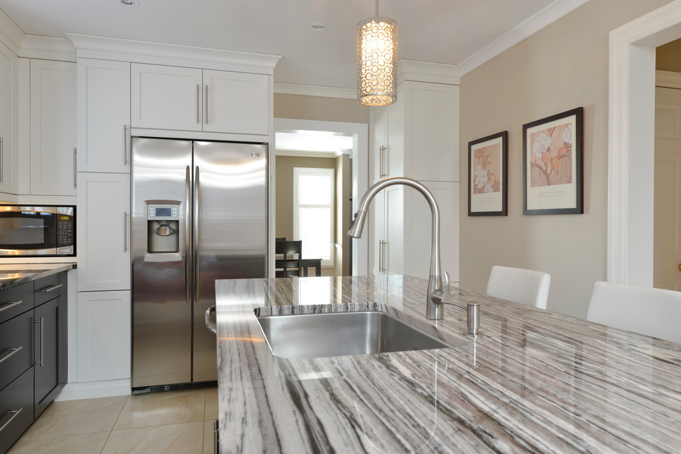 Large transitional u-shaped ceramic tile enclosed kitchen photo in Toronto with an undermount sink, flat-panel cabinets, dark wood cabinets, granite countertops, beige backsplash, matchstick tile backsplash, stainless steel appliances and an island