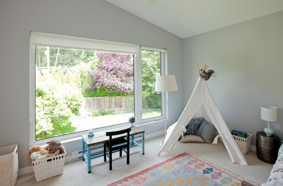 Large transitional gender-neutral kids' playroom in Vancouver with grey walls and carpet for kids 4-10 years old.