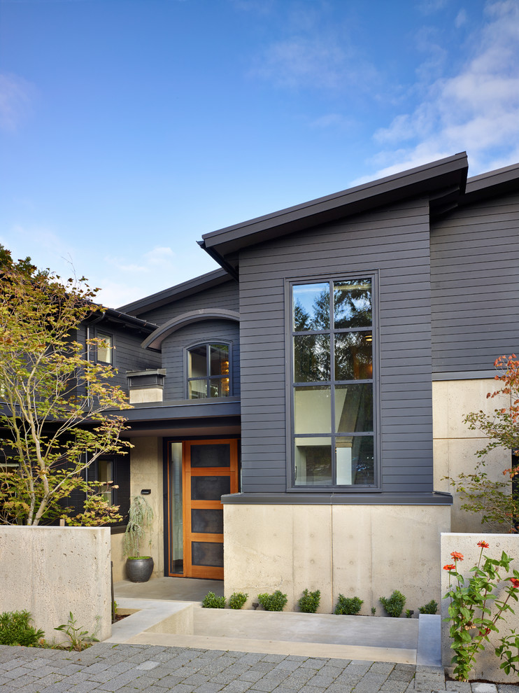 Large contemporary two-storey grey exterior in Seattle with wood siding.
