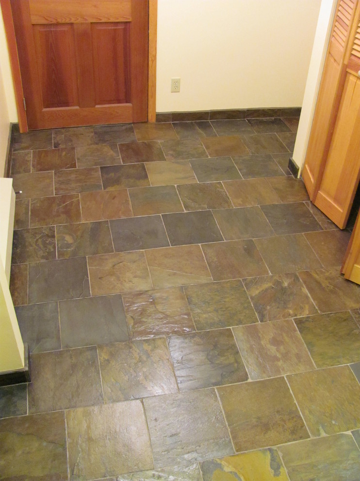 Small mountain style slate floor foyer photo with a medium wood front door