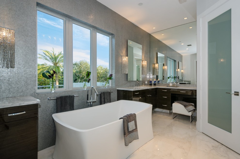 This is an example of a contemporary bathroom in Miami with a freestanding tub.