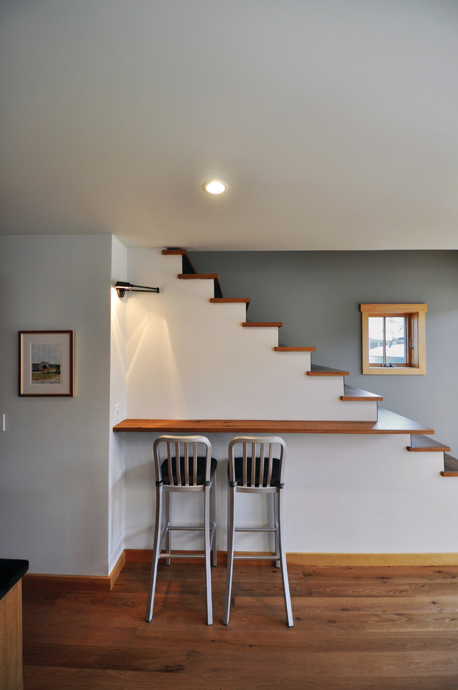 Design ideas for a small country wood straight staircase in Other with painted wood risers.