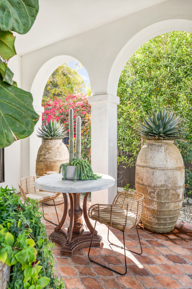 Mid-sized tuscan front yard tile patio photo in Los Angeles