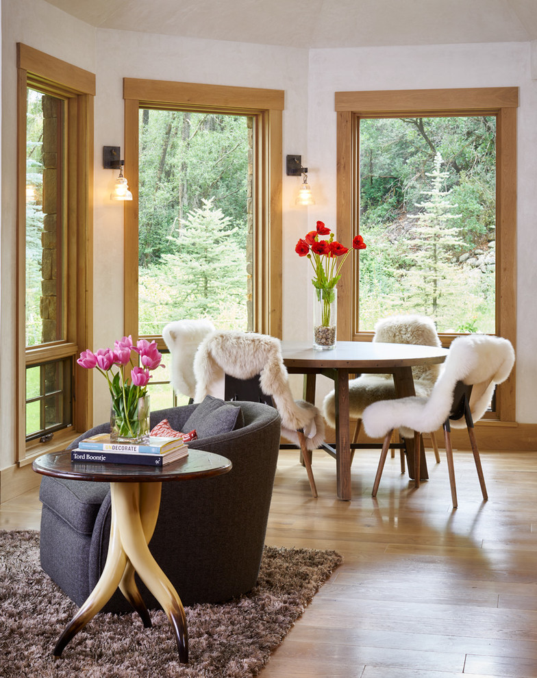 Inspiration for a country dining room in Denver with white walls, light hardwood floors and beige floor.