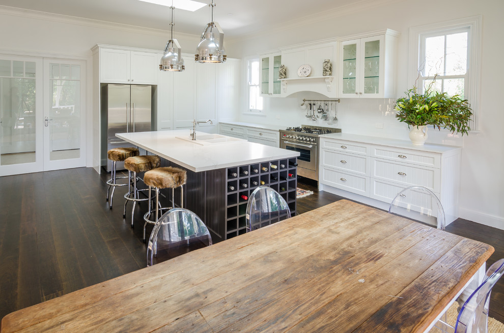 This is an example of a large traditional l-shaped eat-in kitchen in Sydney with shaker cabinets, white cabinets, quartz benchtops, white splashback, subway tile splashback and with island.