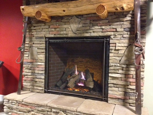 This is the new Heat-N-Glo True-42 direct vent gas fireplace with stacked stone and a ceder fireplace mantel.