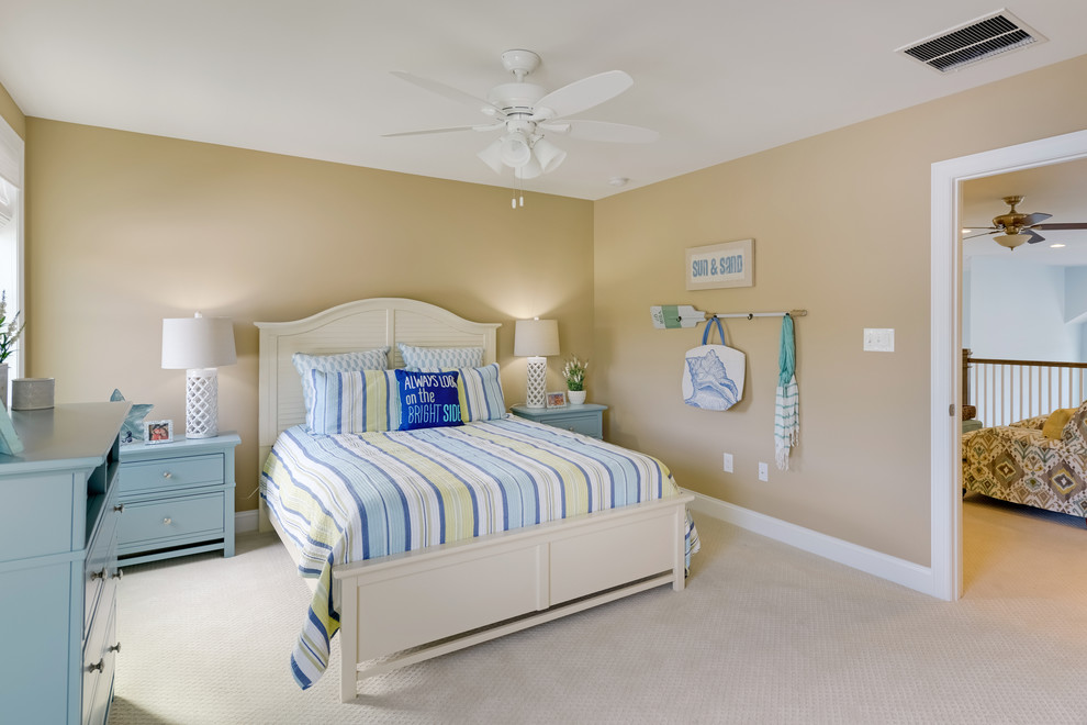 Beach style guest bedroom in Other with beige walls, carpet and beige floor.
