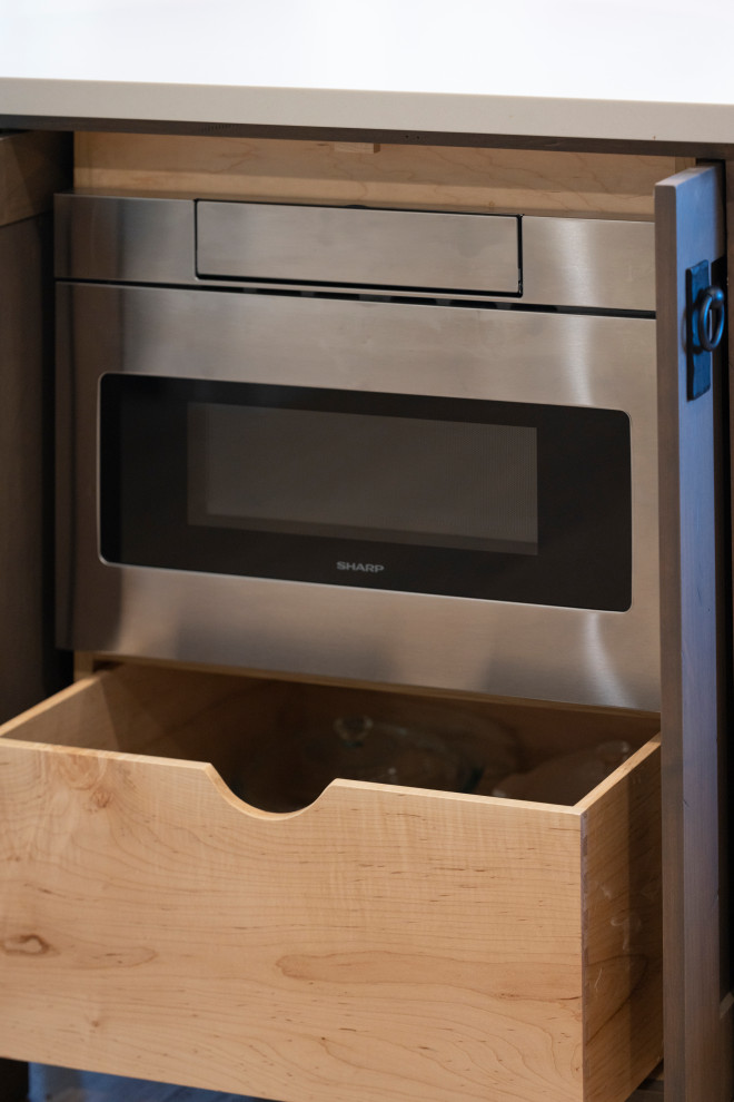 Mid-sized transitional l-shaped laminate floor open concept kitchen photo with a double-bowl sink, flat-panel cabinets, gray cabinets, quartz countertops, white backsplash, ceramic backsplash, stainless steel appliances, an island and white countertops