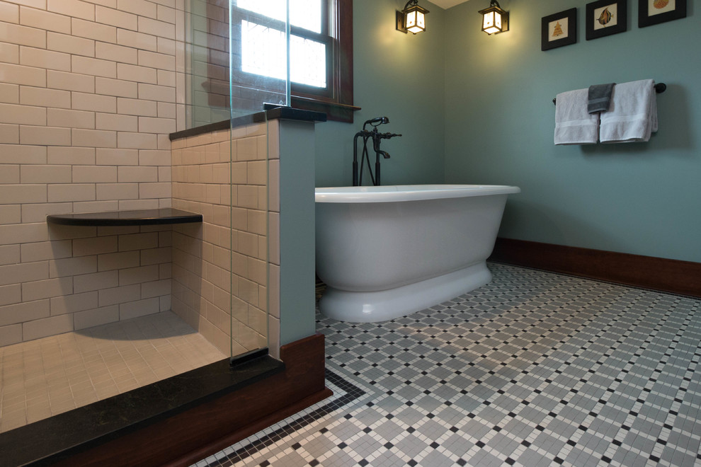 Photo of a mid-sized arts and crafts master bathroom in Detroit with shaker cabinets, dark wood cabinets, a freestanding tub, an alcove shower, a two-piece toilet, black and white tile, porcelain tile, green walls, mosaic tile floors, an undermount sink and soapstone benchtops.