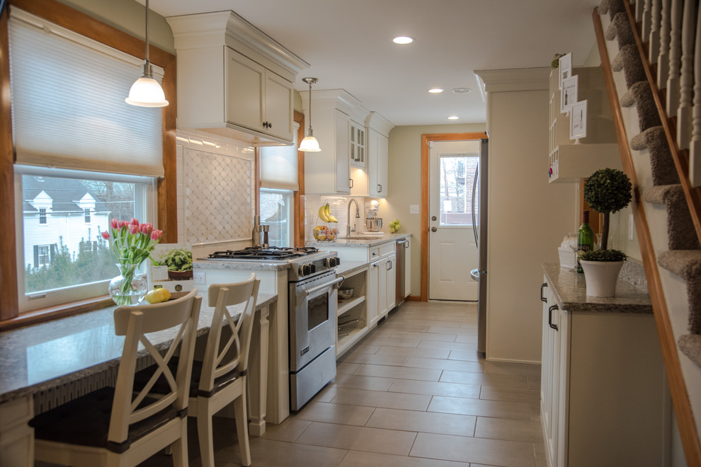 Design ideas for a small traditional galley separate kitchen in Boston with an undermount sink, shaker cabinets, white cabinets, quartz benchtops, white splashback, subway tile splashback, stainless steel appliances and porcelain floors.