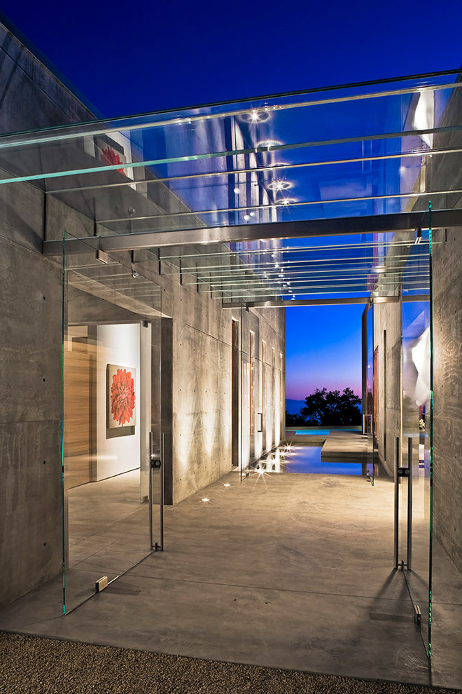 Photo of a modern entryway in Santa Barbara with concrete floors.