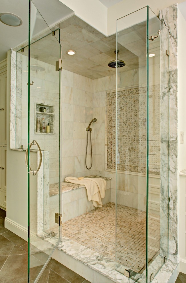 This is an example of a mid-sized traditional master bathroom in New York with beaded inset cabinets, white cabinets, an alcove shower, beige tile, white tile, marble, white walls, porcelain floors, marble benchtops, beige floor, a hinged shower door and an undermount sink.