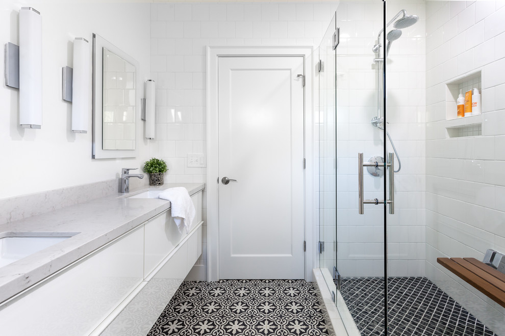 Transitional master bathroom in Sacramento with cement tile, white walls, engineered quartz benchtops, flat-panel cabinets, white cabinets, an undermount sink, black and white tile and a hinged shower door.
