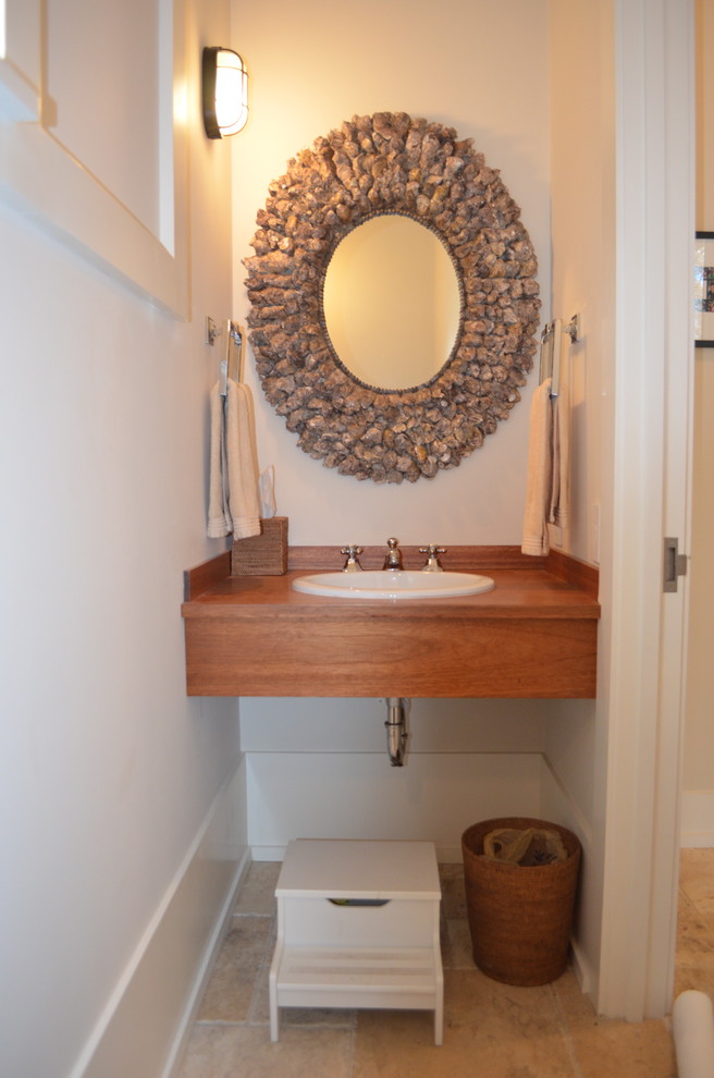 Beach style powder room in Providence.